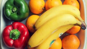 Top View Photography of Yellow Bananas and Two Peppers